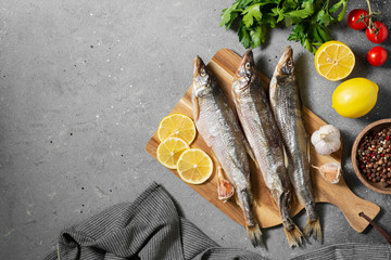 Smoked or dried smelt fish on a wooden Board on a brown wooden table	