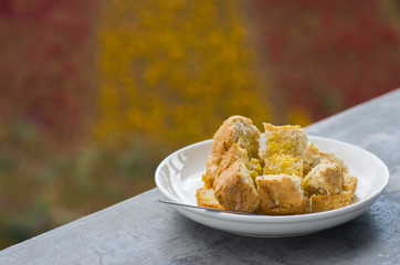 Baked whole wheat bread with milk butter in a white plate