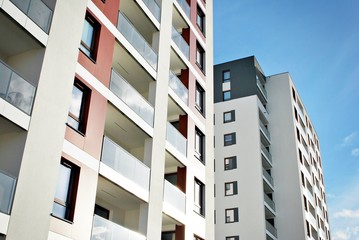  Modern apartment buildings on a sunny day with a blue sky. Facade of a modern apartment building