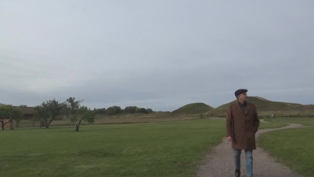 a tourist walking on an old field Uppsala, Sweden