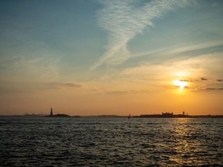 Obraz na płótnie Canvas Liberty island, New York City [ Statue of Liberty on Hudson river during cruise sunset at dusk ]