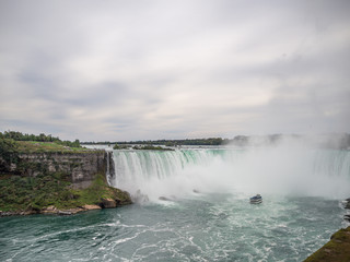 Niagara Falls, New York state, United States of America and Canada - edge of Niagara falls, town from American and Canadian city side, falling water and mist