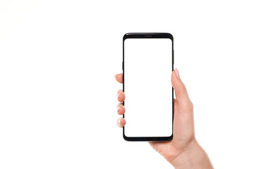 Woman hand holding the black smartphone blank screen with modern frameless design isolated on white background
