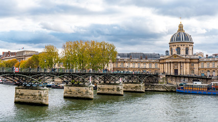 Fototapeta na wymiar View from Pont des arts and Seine river during Autumn season in the afternoon cloudy day . One of the most important bridge in the heart of Paris , France