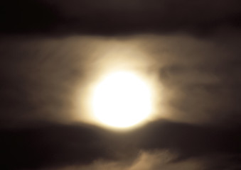 Moon in the night sky. Near the moon a small amount of clouds