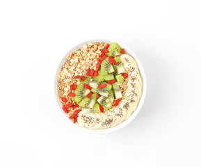 Healthy breakfast smoothie bowl with granola, banana, Goji berries, chia and kiwi on white background. Top view