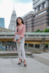 young business woman walking on the street outside office building