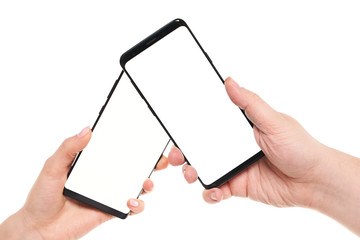 Two hands holding smartphones blank screen with modern frameless design while wireless transferring...