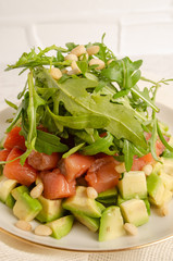 Salad of red fish, arugula, avocado. Dressed with pomegranate juice.