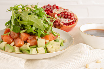 Salad of red fish, arugula, avocado. Dressed with pomegranate juice.