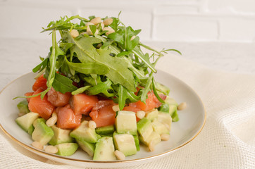 Salad of red fish, arugula, avocado. Dressed with pomegranate juice.