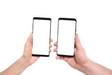 Two hands holding smartphones blank screen with modern frameless design while wireless transferring data NFC connected isolated on white background