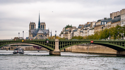 Nice view from Paris Seien river cruise tour and Notre dam cathedral during Autumn season evening . One of the most famous activities which locate in the heart of Paris , France