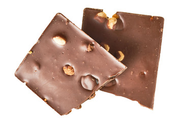 Two halves of rectangular chocolate bar with peanut and raisin isolated on white background