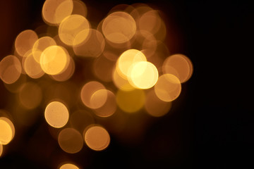 beautiful yellow bokeh lights background on dark