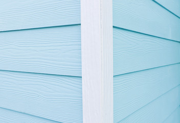 Corner of a wooden house in blue