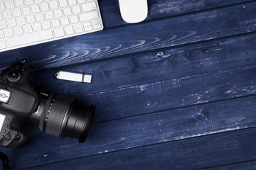 DSLR Camera on blue wood desk, photographer work area