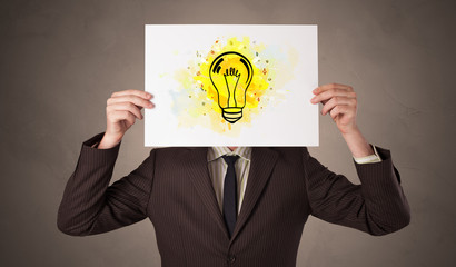 Person holding a paper with a drawn colorful idea concept