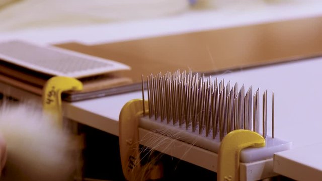 Hair combing when creating a wig. Factory wig production process