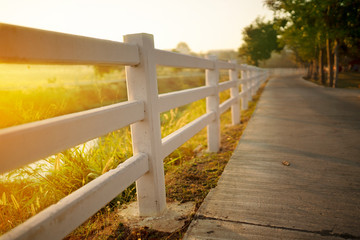 White concrete fence with path way