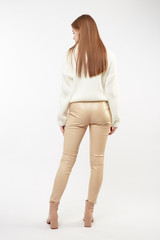 Beautiful sexy pretty girl with long brown hair and perfect body weared in beige leather pants and...