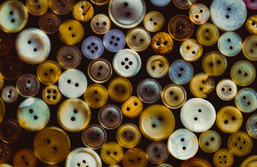 old vintage plastic buttons on black background