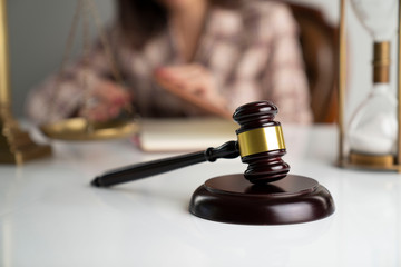 Female layer – businesswoman working in the office. Gavel on the white table.