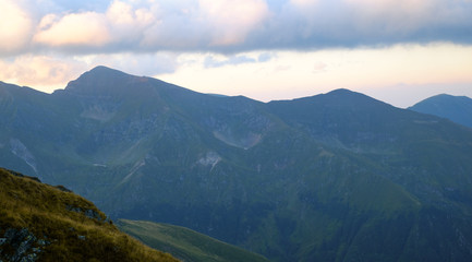 Obraz na płótnie Canvas Sunrise on Fagaras high mountain ridge. Romanian mountain landscape with high peaks over 2200m