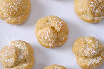 choux cream or cream puff or French profiteroles with fresh cream set on cafe table.