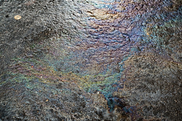 Oil stain on Asphalt road after rain
