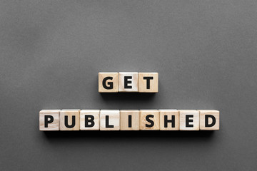 Get published - words from wooden blocks with letters, get published concept, top view gray...