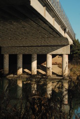 under the bridge, reflection on the water