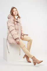 Beautiful sexy pretty girl with long brown hair and perfect body weared in beige leather pants and...