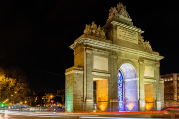 the impressive puerta de Toledo (city gate to Toledo) illuminated during evening. Madrid attracts...