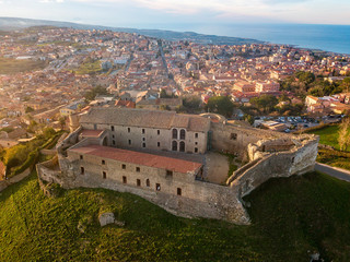 Fototapeta premium Aerial view of the Norman Swabian castle, Vibo Valentia, Calabria, Italy. Overview of the city seen from the sky, houses and rooftops
