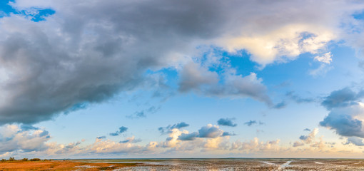 Panorama of a beautiful blue sky filled with gray clouds over over the big lake at Thale Noi Waterfowl Reserve nonihunting area , the famous for its attractions in Thailand.