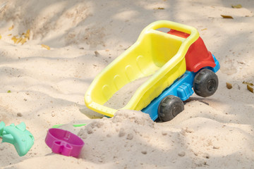 Fototapeta na wymiar Asian baby girl playing sand outdoor. Kid building sand castle.