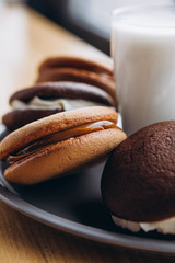 Close up Traditional chocolate and Pumpkin Whoopie pies made with vanilla cream cheese. Background for bakeries, cafes, restaurants