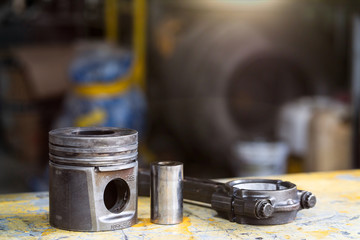 Piston and pin of diesel engine on the table, mechanical maintenance and repair  background