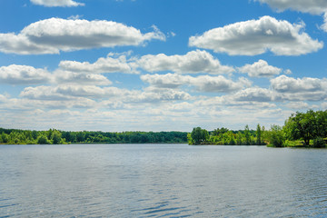 Obraz premium The blue sky with the clouds above the clear blue lake