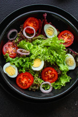 healthy salad vegetables, quail eggs (tomato, lettuce and other ingredients) menu concept. food background. top view. copy space