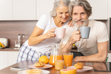 Smiling man and his wife drinking tea