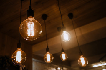 Decorative antique edison style light bulbs against brick wall background.