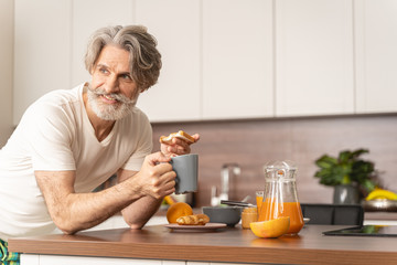 Relaxed happy Caucasian man having a snack