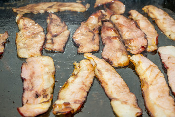 Bacon toasting on the grill, delicious