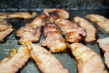 Bacon toasting on the grill, delicious