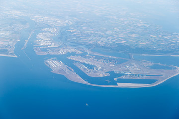 aerial view from window of an airplane looking over the Rotterdam port and the North Sea