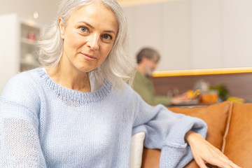 Beautiful tranquil Caucasian woman sitting at home