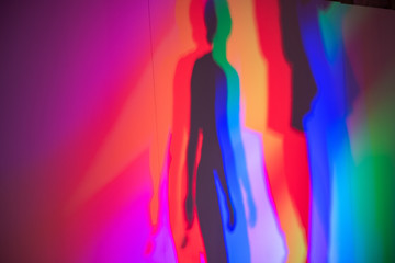 Fototapeta na wymiar Colorful shadows of two people on dance floor