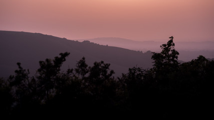Hills in East Sussex with layers of mist viewed from Butts Brow in the South Downs National Park